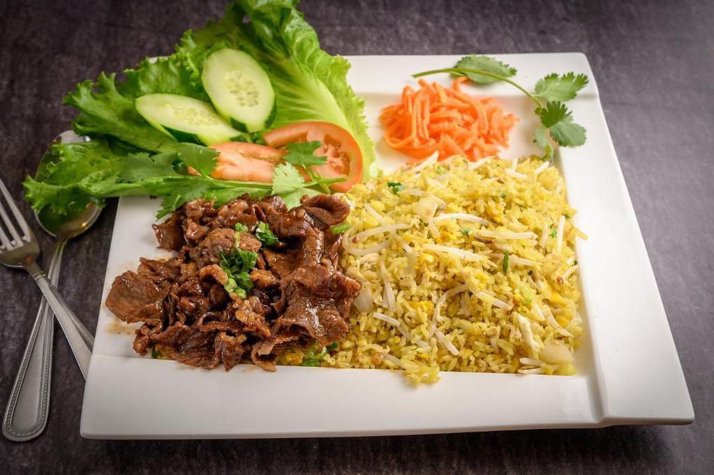 Shredded Beef Ribeye Fried Rice · Seasoned yellow garlic fried rice with shredded grilled beef , egg , onion, beansprout.. Garnish: Lecture , Cucumber , tomato , carrot.