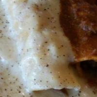 Chicken Enchilada Dinner · Two chicken enchiladas covered with sour cream sauce and Monterrey Jack cheese served with r...