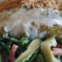 Galveston Enchiladas · Two shrimp and crab enchiladas topped with green sauce served with rice and avocado salad.