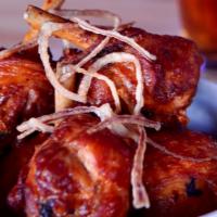 Chicken Lollipops · Five Frenched chicken legs, deep-fat fried, tossed in extra-buttery buffalo sauce, topped wi...