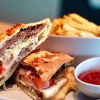 The Pastrami · Warm pita filled with pastrami, dressing, sauerkraut, tomato and gruyere + side of hand-cut ...
