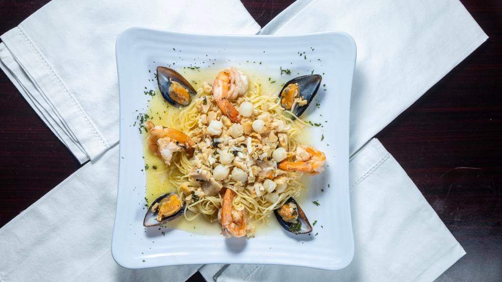 Seafood Combo · Grilled salmon sauteed with mussels, clams, scallops, shrimps & scampi sauce.