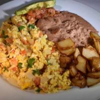 Tex-Mex Migas  Ta'Qo · Scrambled Eggs with Pico, fried corn strips, Hardwood Bacon, and served a 12