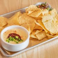Beer Cheese Queso & Guacamole · bowl of Monterey jack and sharp cheddar cheese queso made with On Rotation beer served with ...