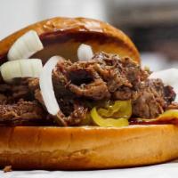Brisket Sandwich · Our famously smoked brisket on a toasty bun topped with bbq sauce, mustard, onions, and pick...