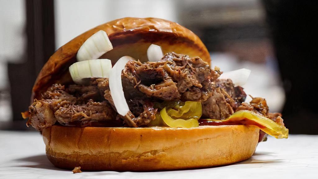 Brisket Sandwich · Our famously smoked brisket on a toasty bun topped with bbq sauce, mustard, onions, and pickles.