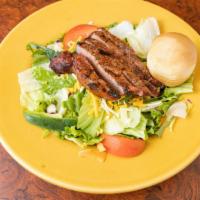 Grilled Steak · Strips of tender mesquite-grilled sirloin on green lettuce, with shredded cheese, cucumber, ...