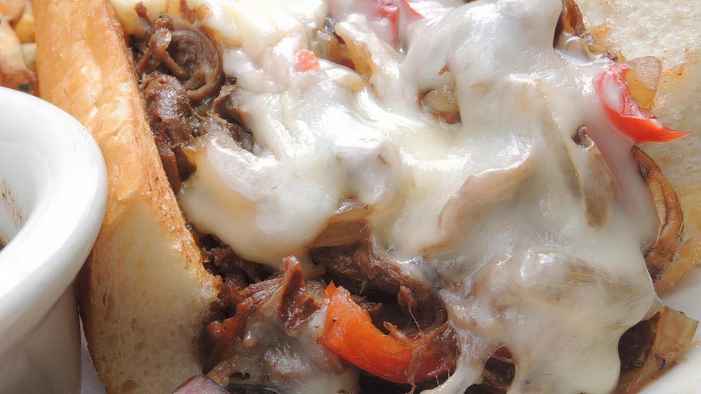 Guinness Cheesesteak · Guinness-braised ribeye, with caramelized peppers & onions, sauteed mushrooms, and Swiss cheese on a hoagie roll. Served with fries and Au Jus.