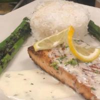Pan Seared Salmon · Pan seared salmon topped with a dill cream sauce. Served alongside Basmati rice and green be...