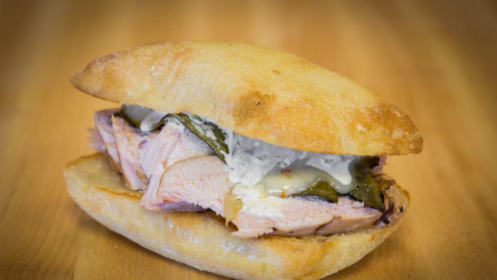 Chicken Poblano · ONE90 smoked chicken breast with poblano peppers, red onions, melted jack cheese, and jalapeño ranch dressing on ciabatta.