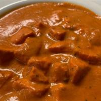 (Cn) Butter Chicken · Tandoor-roasted chicken kebab pieces sautéed in a creamy buttery sauce and garnished with fe...