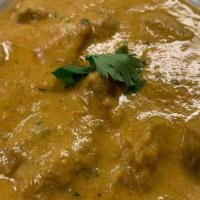 (Cn) Korma · Meat cooked in garlic- and onion-rich sauce with cashews and a touch of cream. 16 oz.