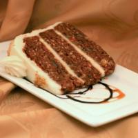 Carrot Cake · Three layers of moist carrot cake loaded with carrots, coconut, pineapple, and walnuts drenc...