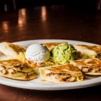 Chicken Quesadilla · Three flour tortillas filled with grilled chicken fajitas and melted jack cheese, topped wit...
