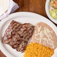 Carne Asada (House Favorite) · grilled skirt steak garnished with house sauce and melted jack cheese. Served with rice and ...