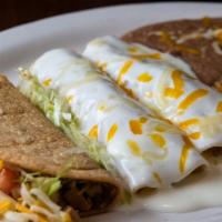 Two Cheese Enchiladas & One Beef Crispy Taco · Enchilada topped with chile con carne sauce.