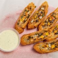 Southwest Eggrolls · Filled with spicy chicken, black beans, corn, spinach and cheese served with jalapeño ranch.