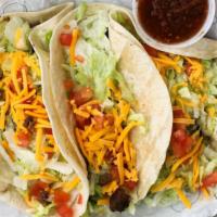 Soft Beef Tacos · Three flour tortillas filled with seasoned ground beef, lettuce, cheddar cheese and tomatoes...