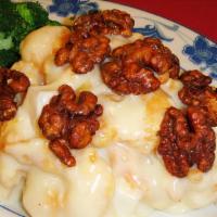 Walnut Shrimp · Shrimp, pineapple cooked with honey cream sauce topped with candied walnuts with steamed bro...