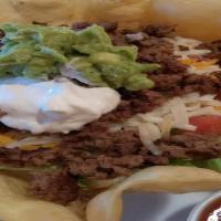 Taco Salad · Lettuce mix, ground beef or grilled chicken, with cheese, beans, guacamole, sour cream and p...