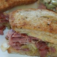 New Classic Reuben · Corned beef, sauerkraut, apples, Swiss cheese and home-made 1001 island dressing on toasted ...