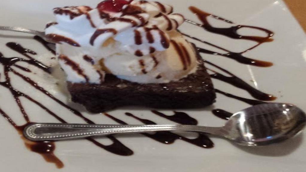 Hot Fudge Brownie · Warm Brownie, topped with French Vanilla ice cream, hot fudge, whip cream and a cherry.