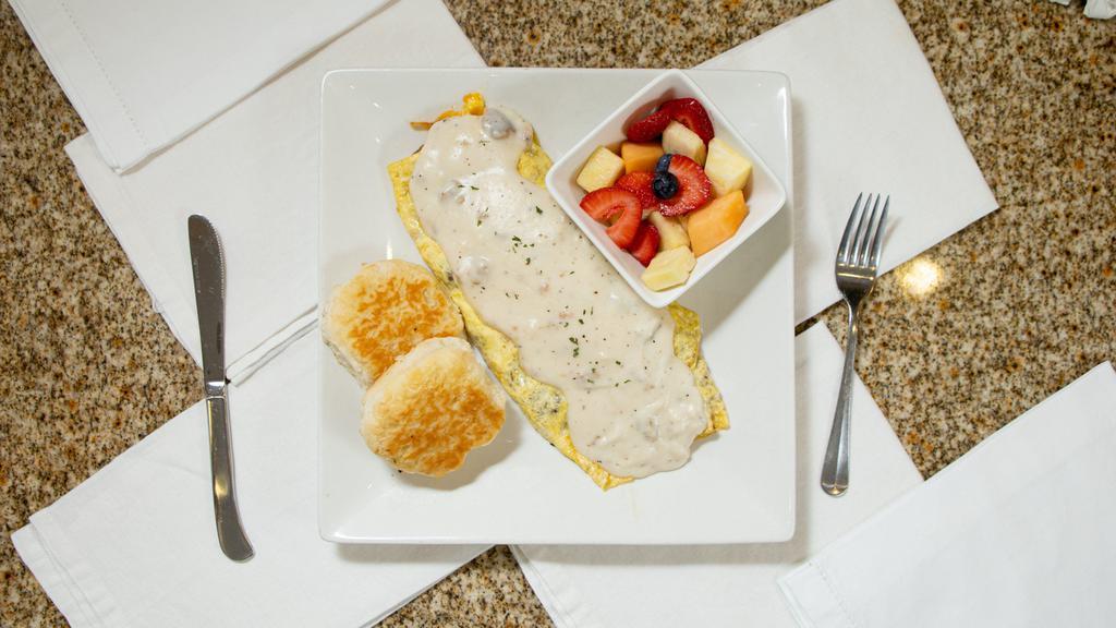 Townhouse Omelet · Sausage, onion, hash browns, cheddar cheese, topped with home-made sausage gravy.