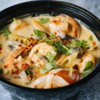 Tom Kha · Chicken broth based with a mix of spices and coconut milk with green onions, mushroom, white...