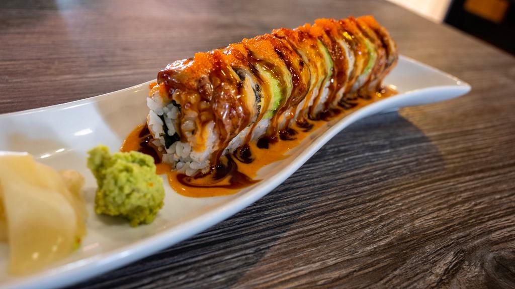 Dragon Roll · Cucumber, avocado, cream cheese crab, shrimp tempura, topped with eel and avocado and three special sauces on top.