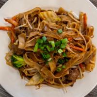 E13 Phat Se-Ew · Stir fried wide rice noodles with eggs, broccoli, carrots, onions, and bok choy in delicious...