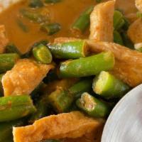 E2 Panang Curry · Rich creamy panang curry in coconut milk sauce with lemon leaf, basil with peanuts, and bell...
