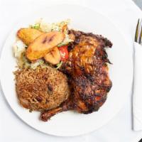 Jamaican Jerk Chicken · With rice and peas, steamed cabbage and plantain (bone-in chicken marinated overnight in our...
