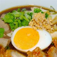 Kuay Jab · Rolled noodles in a savory brown broth with crispy pork belly, boiled egg, fried tofu and po...