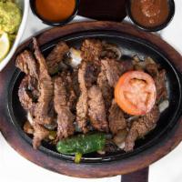Fajitas Asadas · Charbroiled beef fajita grilled with onions, bells peppers, grilled peppers. Served with ric...
