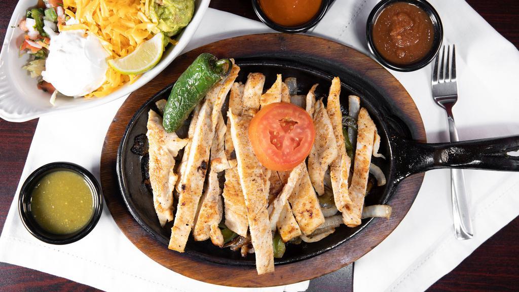 Fajitas De Pollo · Chicken fajita grilled with onions, bell peppers, grilled peppers. Served with rice, beans, salad, guacamole, and sour cream.