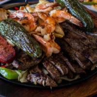 Parrillada Mixta (2) · Beef & Chicken Fajitas, Grilled shrimp and spicy sausage. Served with rice, refried beans, p...