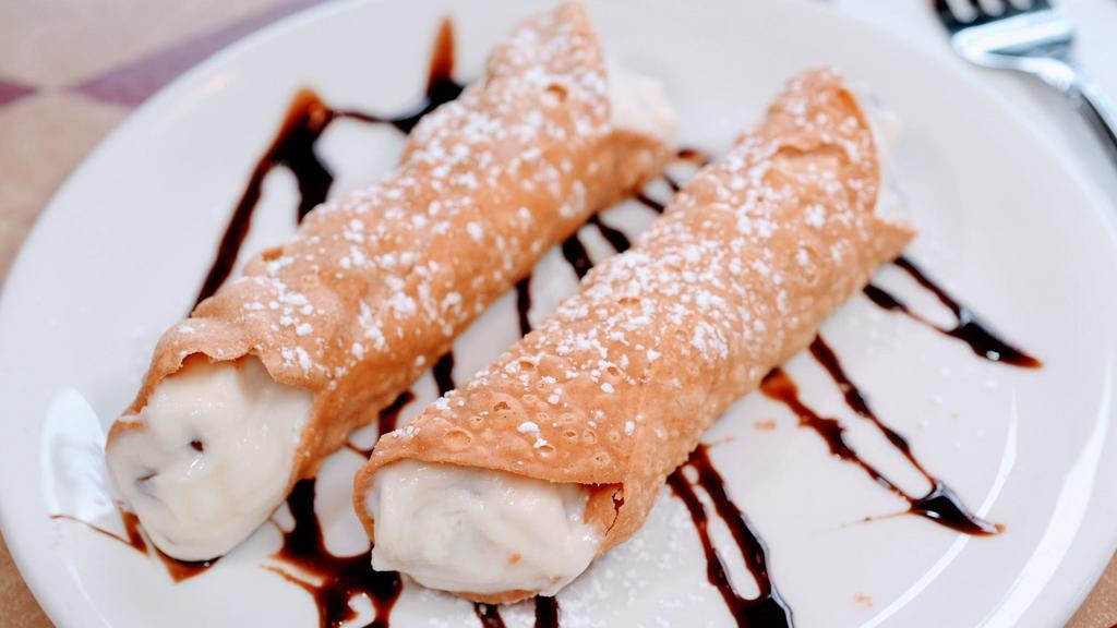 Cannoli · The perfect way to end your meal! Two crispy tube-shaped shells made of pastry dough, filled with a sweet, ricotta and chocolate chip filling. Finished with a dusting of powdered sugar.