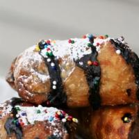 Fried Snickers · Deep-fried Snicker bar, topping choices : caramel drizzle or powdered sugar.