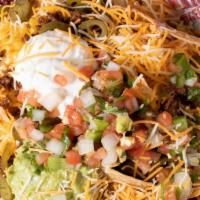 Stomp'S Nachos · TACO SEASONED GROUND BEEF, TORTILLA CHIPS, CHEDDAR/JACK BLEND, BEANS, TOPPED WITH GUACAMOLE,...