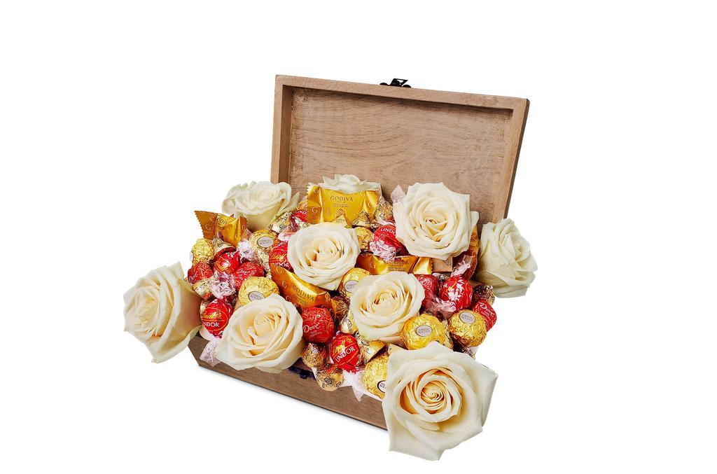 Treasure Chest · The Treasure Chest features a reusable wooden gift box, Premium Roses and an assortment of our finest chocolate
- Ferrero Rocher
- Godiva Master Pieces Milk Chocolate Hazelnut
- Lindt Lindor Milk Chocolate Truffles 
- Dove Promises Dark Chocolate
- Hershey's Milk Chocolate Almond Kisses