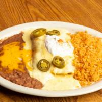 Enchilada Dinner · Two enchiladas served with Mexican style rice and refried beans.