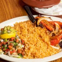Carne Asada · Grilled sirloin strip, topped with grilled onions and tomatoes, served with rice, guacamole,...