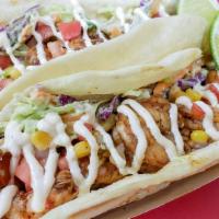 Shrimp Tacos · Blackened shrimp served over a creamy avocado slaw topped with corn salsa and drizzled with ...