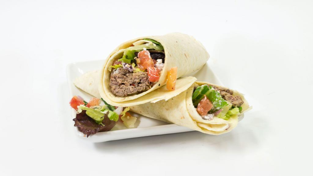Beef Kobida Kebab Wrap · Beef Kobida Kebab wrapped up in a lavash bread along with spring mix, tomatoes, onions, yogurt sauce, cilantro sauce, and seasonings!