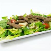 Gyro Salad · Gyro over a bed of greek salad, house dressing, yogurt sauce, cilantro sauce, and seasonings!