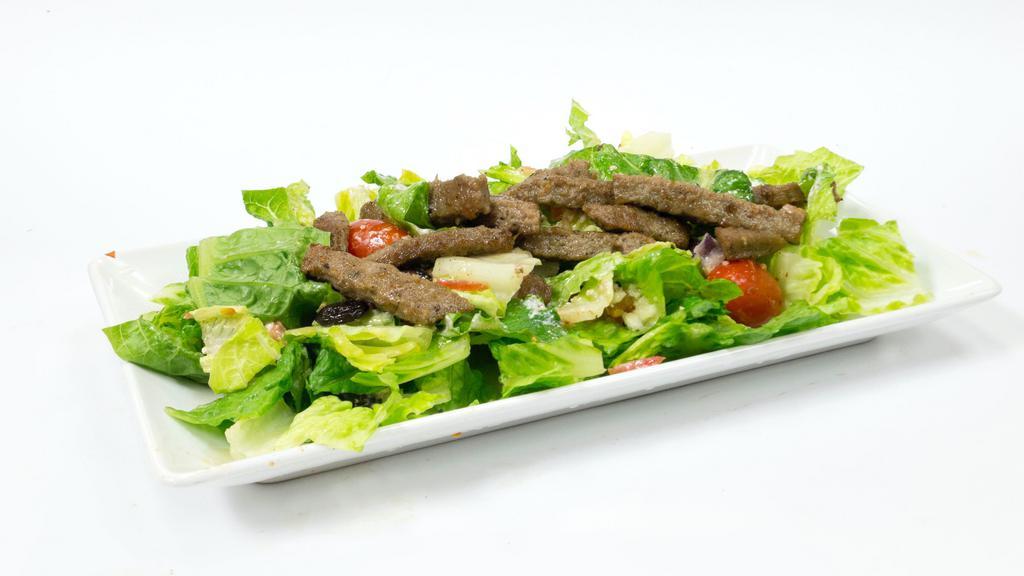 Gyro Salad · Gyro over a bed of greek salad, house dressing, yogurt sauce, cilantro sauce, and seasonings!