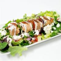 Salmon Kebab Salad · Salmon Kebab over a bed of greek salad, house dressing, yogurt sauce, cilantro sauce, and se...
