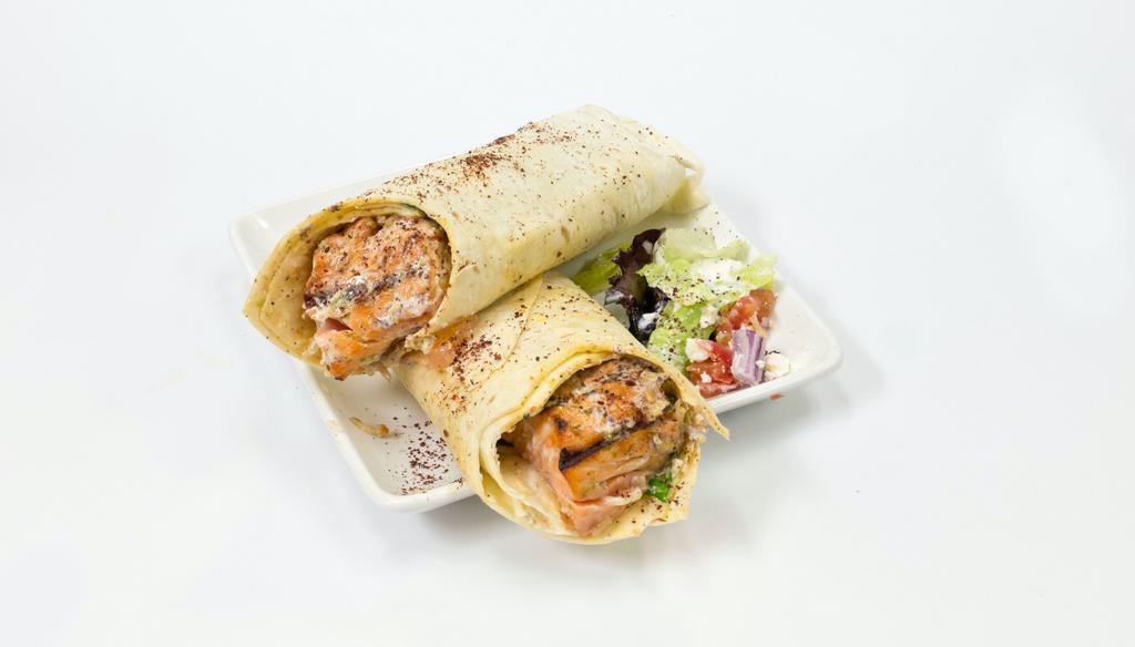 Salmon Kebab Wrap · Salmon Kebab wrapped up in a lavash bread along with spring mix, tomatoes, onions, yogurt sauce, cilantro sauce, and seasonings!