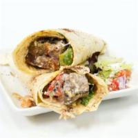 Lamb Kebab Wrap · Lamb Kebab wrapped up in a lavash bread along with spring mix, tomatoes, onions, yogurt sauc...