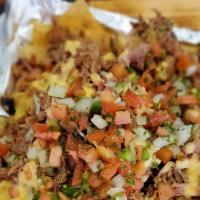 Pulled Pork Nachos · Freshly fried tortilla chips topped, Pico, queso  and slow smoked pulled pork.